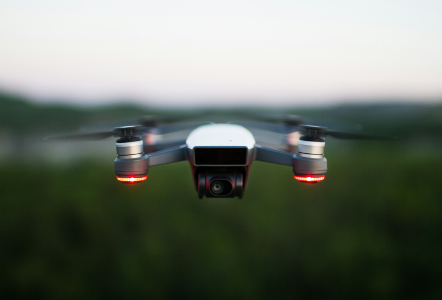 Drone flying over blurred image of a field